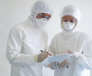 doctor and nurse wearing PPE and looking for corona/covid-19 virus infected patient's laboratory report